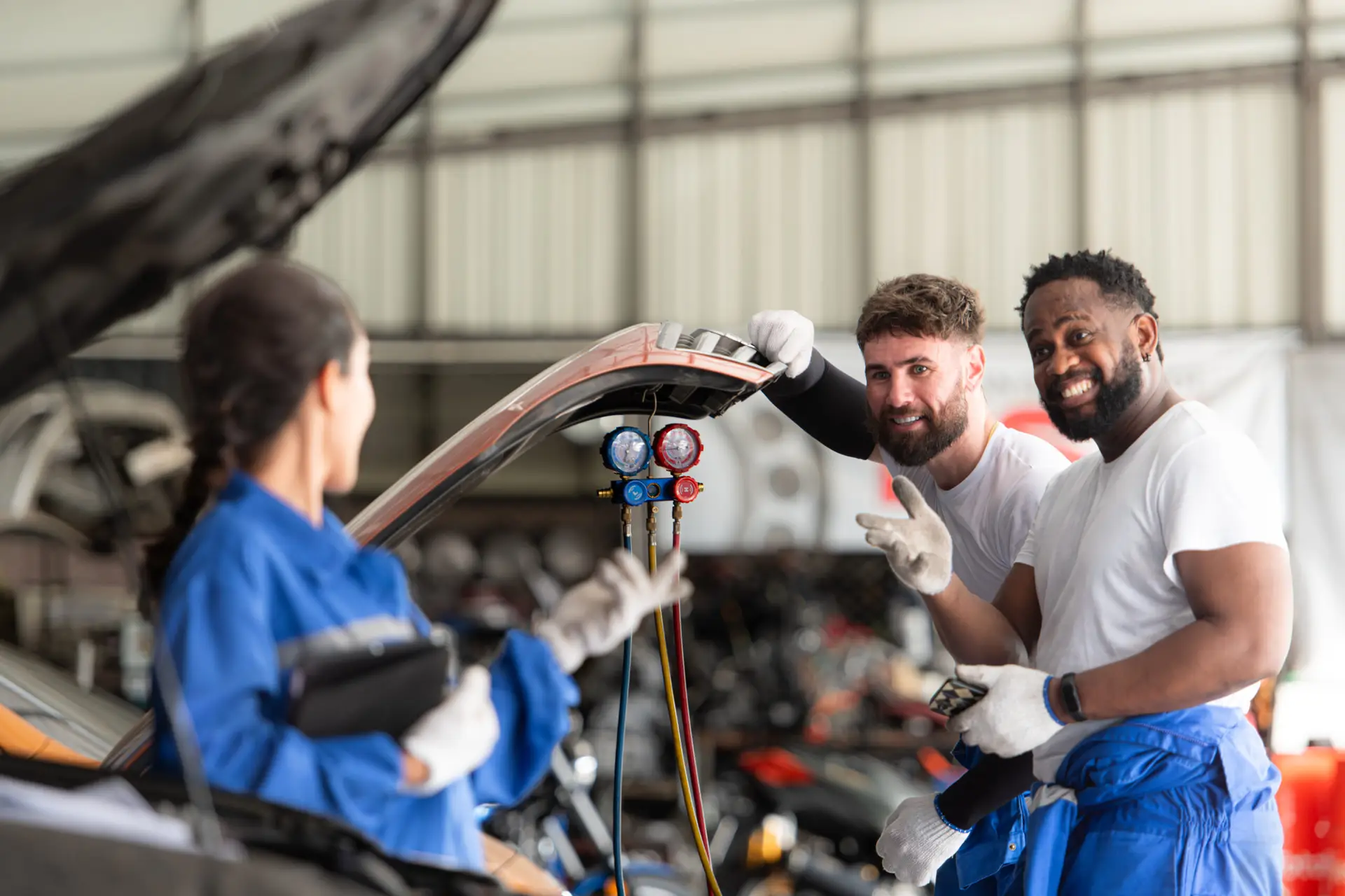 Car mechanic working in an auto repair shop, inspecting the oper